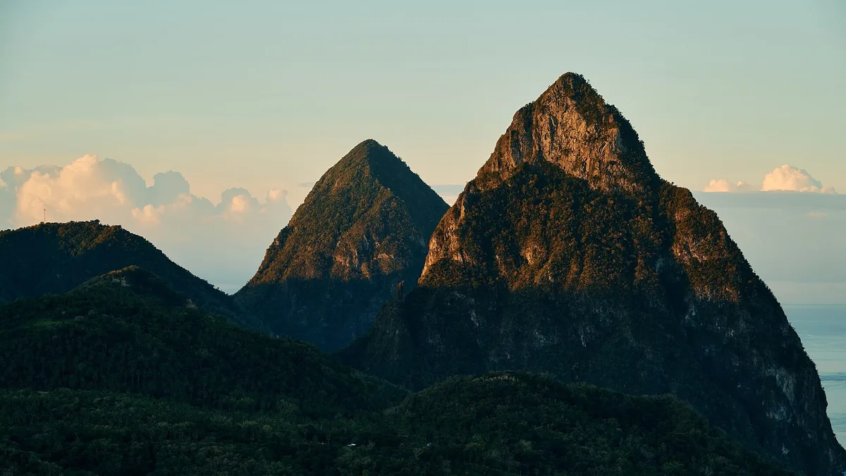 The twin volcanic peaks of Gros Piton and Petit Piton on Saint Lucia in warm evening light