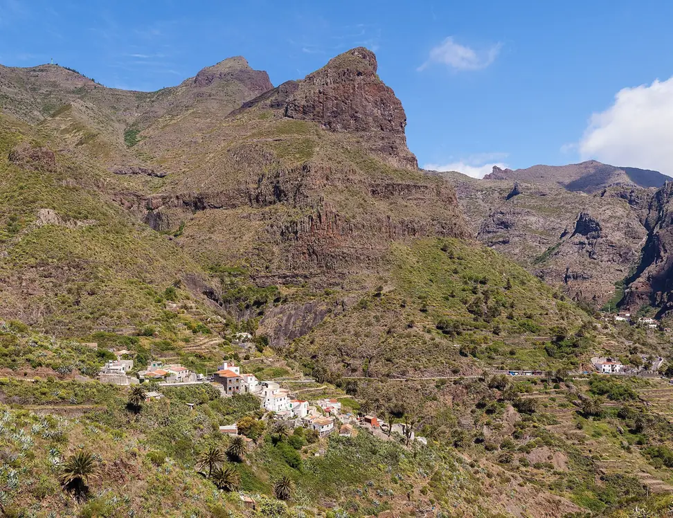 The hamlet of Masca clinging to a green ridge below the jagged peaks of the Teno Mountains on Tenerife