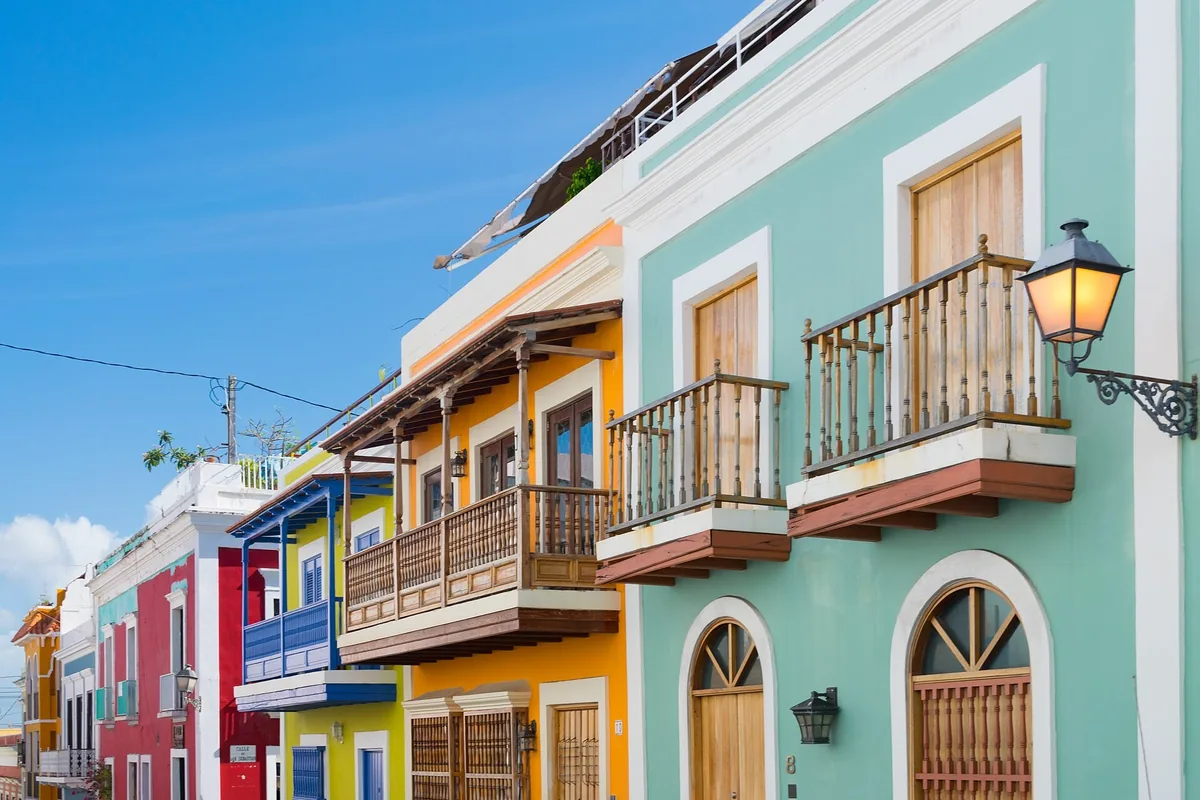 Brightly painted colonial houses with wooden balconies and a street lamp in Old San Juan, Puerto Rico