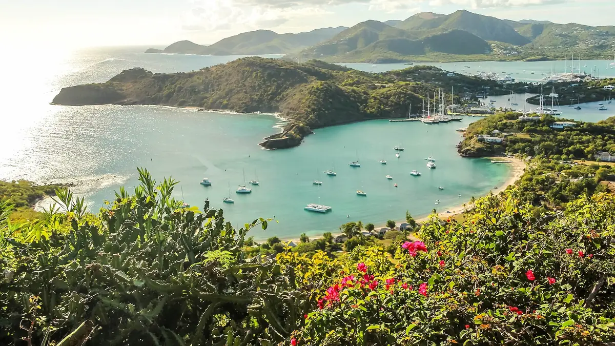 Yachts anchored in English Harbour, Antigua, seen from Shirley Heights with green hills behind
