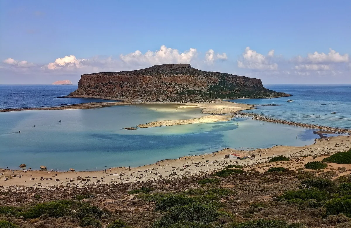 The shallow turquoise lagoon and sand spit of Balos on Crete, with a rocky headland beyond