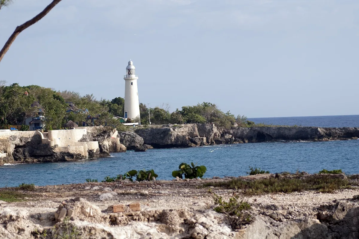 White Negril Lighthouse above the low limestone cliffs of Jamaica's West End coast