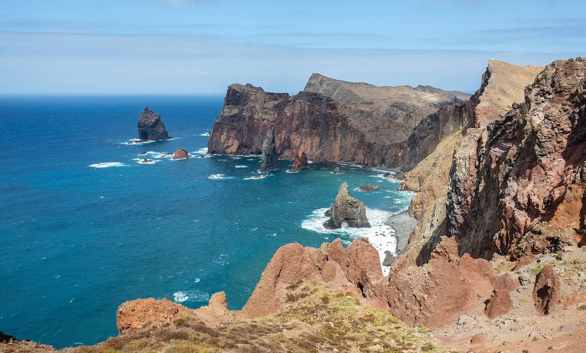Red and brown volcanic cliffs and sea stacks of the Ponta de São Lourenço peninsula on Madeira