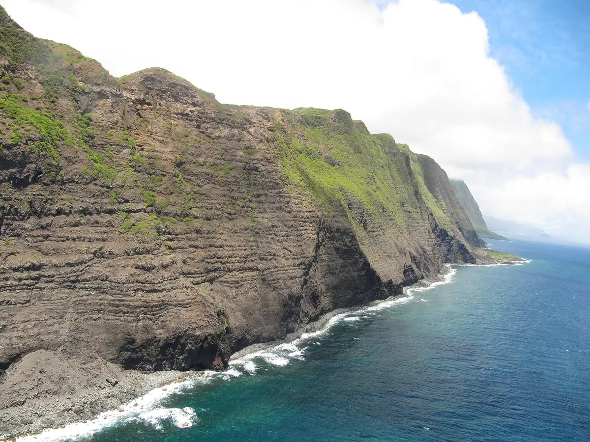 Green-topped sea cliffs plunging into the blue Pacific along the north shore of Molokai