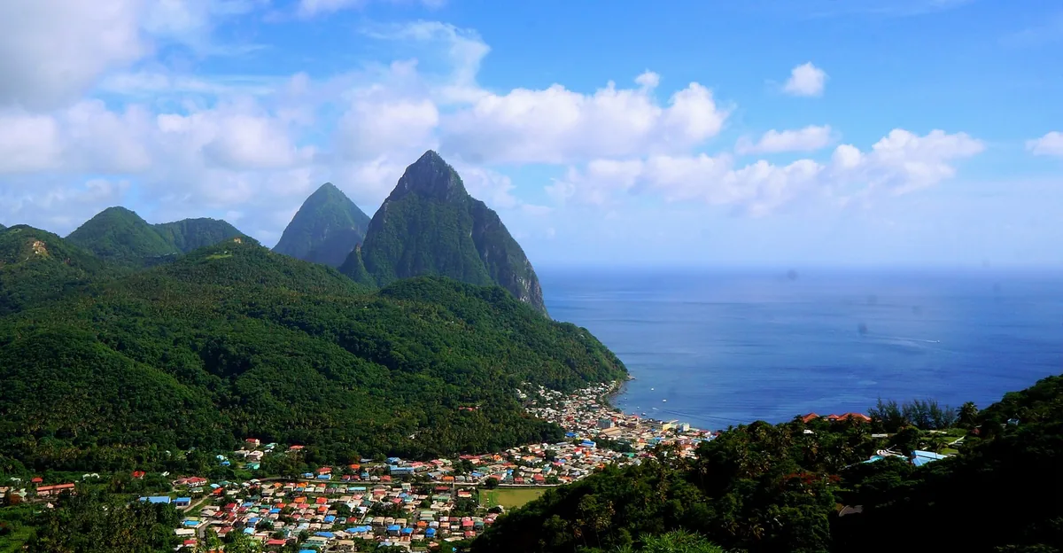 Gros Piton and Petit Piton rising above the green hills and colourful town of Soufrière on Saint Lucia